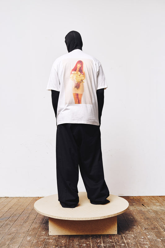 Man wearing a white T-shirt by A BIT FRESH AIR with a digital print of singer Cher on the back – striking streetwear design.